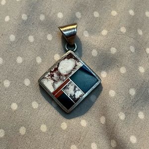 Native American handmade, signed and stamped inlaid pendant.